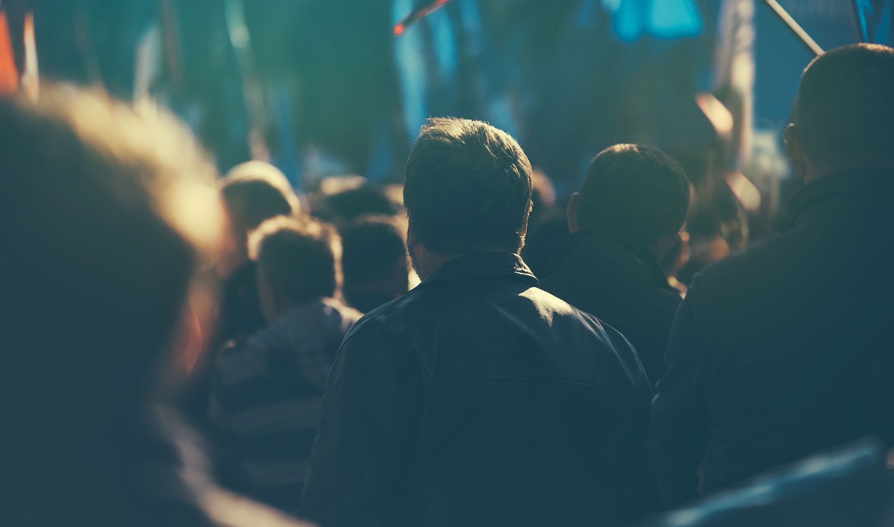 Abstract image of the back of a crowd at a public event.